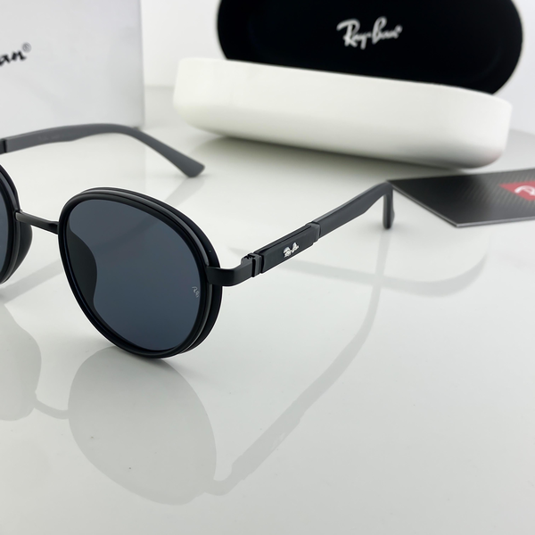 Ray-Ban Sunglasses Round Frame Black Lens are designed for those who value timeless elegance combined with everyday comfort. Crafted with precision, these sunglasses bring together the brand’s iconic heritage and modern trends, making them a versatile accessory for any wardrobe. Featuring a round black frame, this pair carries a minimalist yet bold character. The black dark lenses provide maximum sun protection while keeping your look sleek and understated. Whether you are heading out for a casual day, a drive, or a beach outing, these sunglasses elevate your appearance instantly. 🔑 Key Features: Brand: Ray-Ban Frame Style: Round Frame Color: Black Lens Color: Black (Dark) Gender: Unisex – suitable for both men and women Material: Premium metal-acetate blend ✨ Why Choose Ray-Ban Round Sunglasses? Ray-Ban has been a global leader in eyewear for decades, representing luxury, functionality, and unmatched style. The round frame is a symbol of vintage charm that remains evergreen in the fashion world. This model effortlessly combines durability and comfort, ensuring you can wear them all day without strain. These sunglasses feature UV-protective lenses that shield your eyes from harmful sun rays while giving you a sharp, clear vision. The lightweight yet sturdy construction ensures long-lasting wear, making it an excellent investment for style-conscious individuals. 🎯 Styling Tips: Pair with casual denim and a plain tee for a cool off-duty look. Match with a blazer or semi-formal outfit for effortless sophistication. Perfect companion for beachwear, summer vacations, and daily commutes. 📦 Packaging: Each pair comes with a normal protective box. For those who want an elevated unboxing experience, we also offer an additional premium box option available at extra cost. ✅ Conclusion: If you are looking for a stylish, versatile, and durable sunglass that works across all occasions, the Ray-Ban Sunglasses Round Frame Black Lens is a perfect choice. A true blend of classic and modern fashion, this pair is ideal for both men and women who want to stand out with elegance.